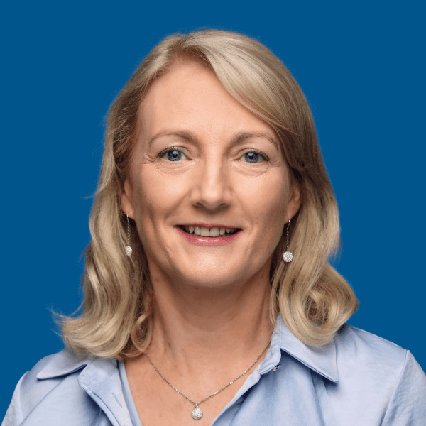 Headshot of Grace Doyle, blue background