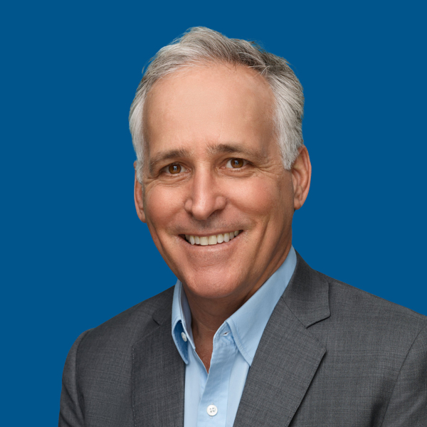 Headshot of Richard Pops, blue background