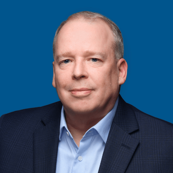 reg Headshot of Tom Skoff, blue background