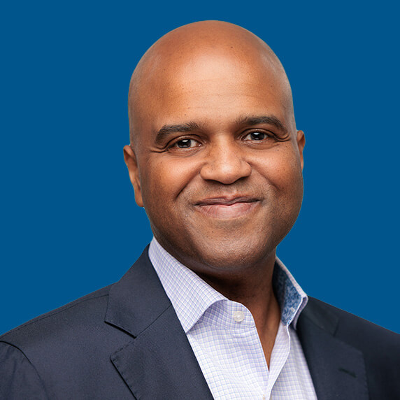 reg Headshot of Joshua Reed, blue background