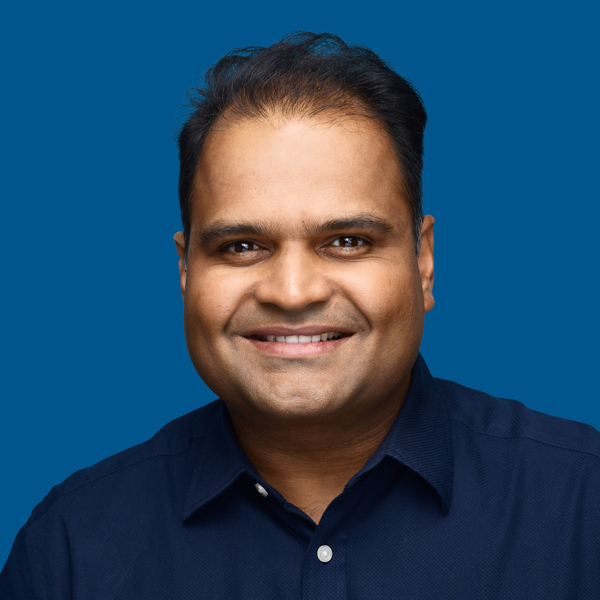Headshot of Bhaskar Rege, blue background