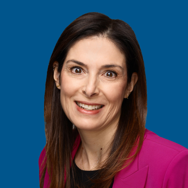 Headshot of Anne Giovanoni, blue background