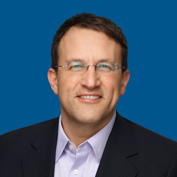 Headshot of Dave Gaffin, blue background