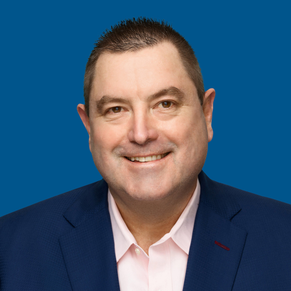 Headshot of Craig Hopkinson, blue background