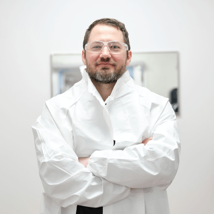 Man sitting in front of green background at Alkermes office.