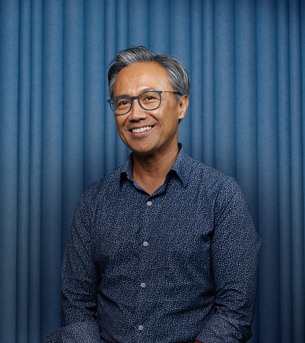 portrait of smiling man stading in wooded area