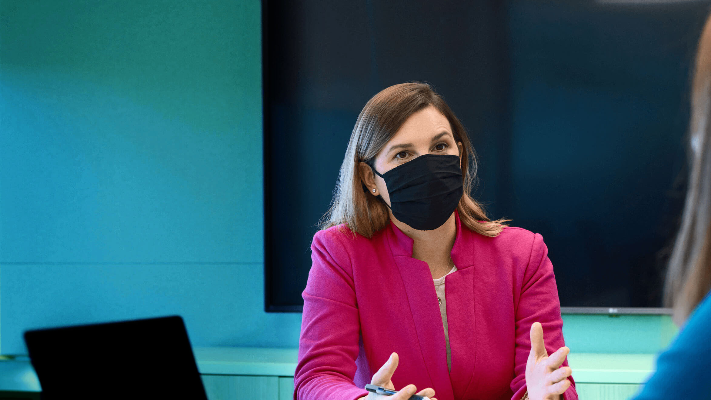 Business woman in mask at meeting in conference room at Alkermes