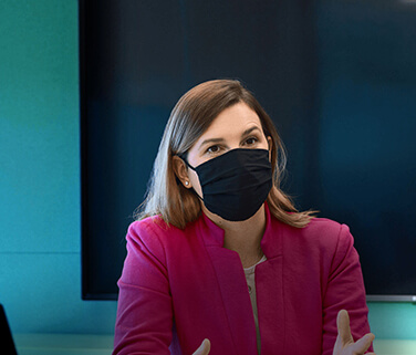 Business woman in mask at meeting in conference room at Alkermes