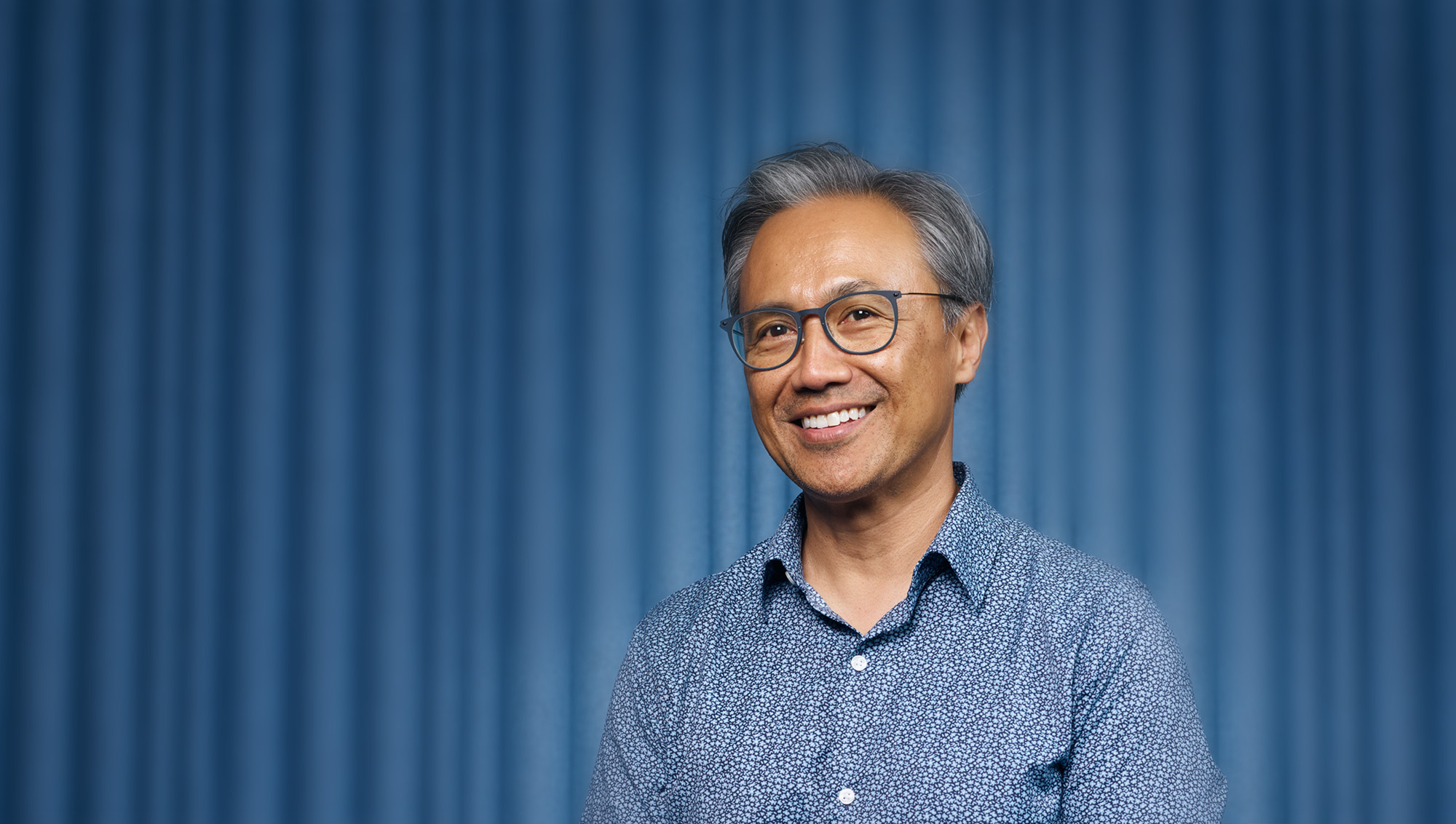 portrait of smiling man stading in wooded area